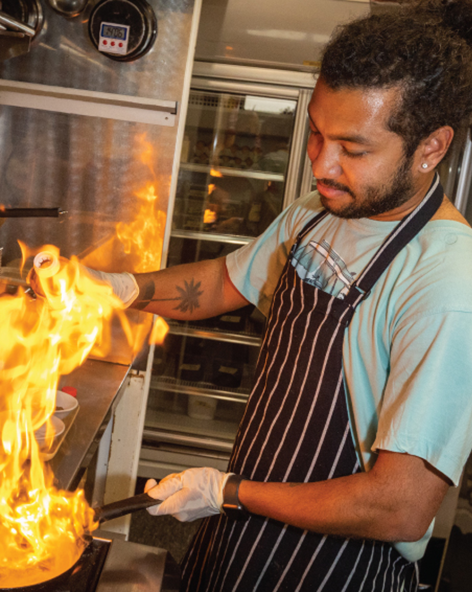 Man cooking over flame
