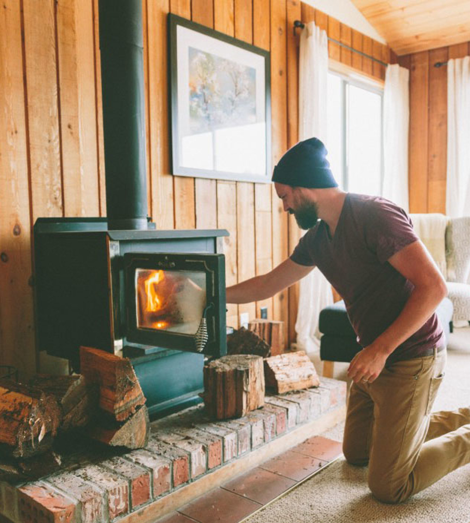 Man opening wood burner