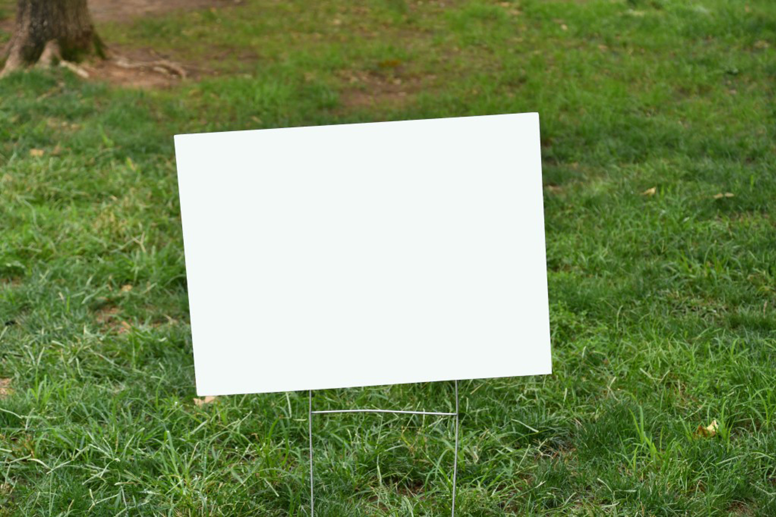 Empty sign on a grass area