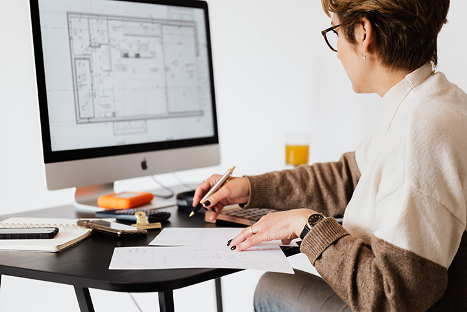 Woman looking at plans on a computer